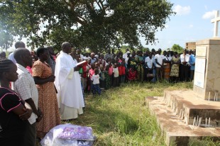 Community members participate in a memorial for the Lukodi massacre of 2004, Lukodi 19 May 2015.