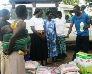 Patrick Odong giving Women's Advocacy Network women’s group in Barlonyo tips on how to use herbicides consignment as part of Redress for SGBV project in 2015. 